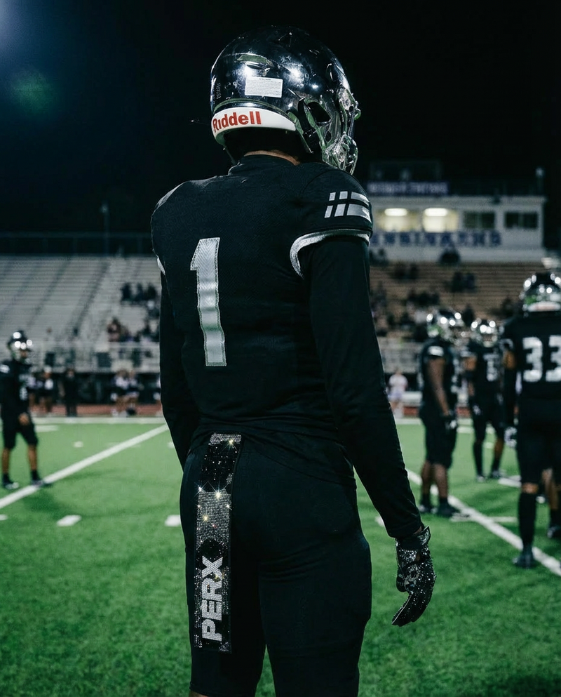 Football player in black uniform wearing Perx Camo Rhinestone Gloves