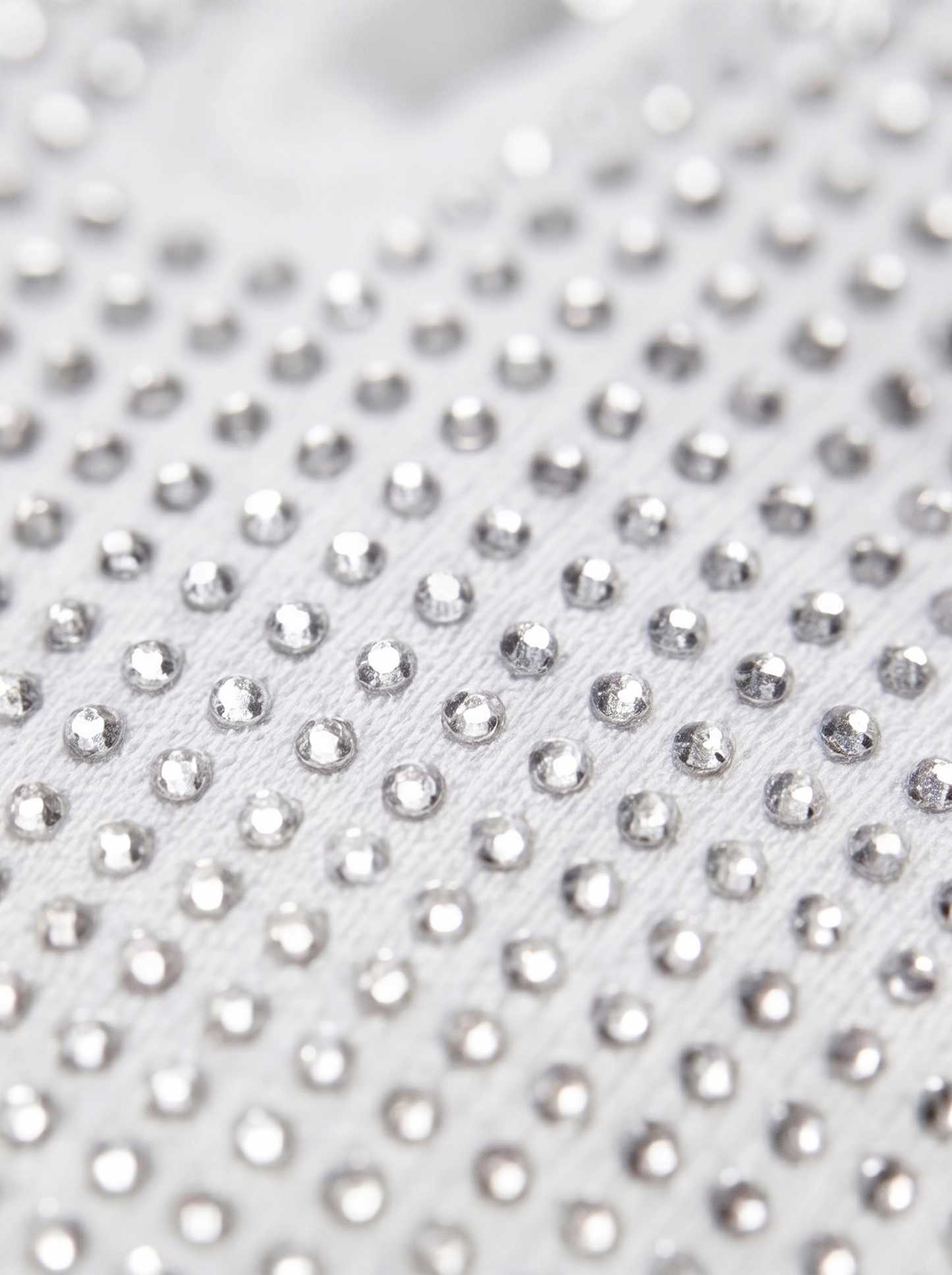 Close-up of a white fabric with silver rhinestones