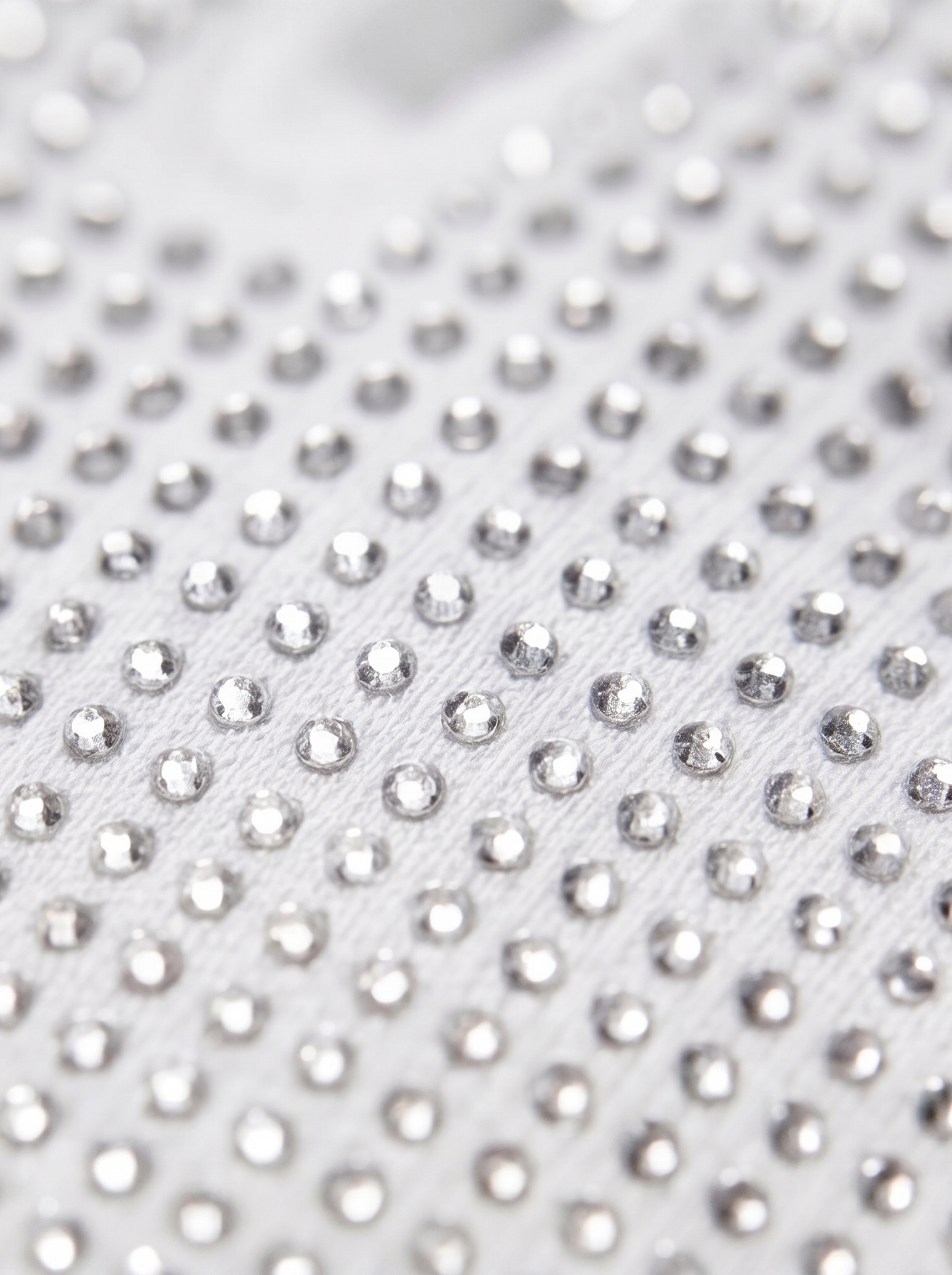Close-up of a white fabric with silver rhinestones