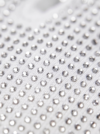 Close-up of a white fabric with silver rhinestones